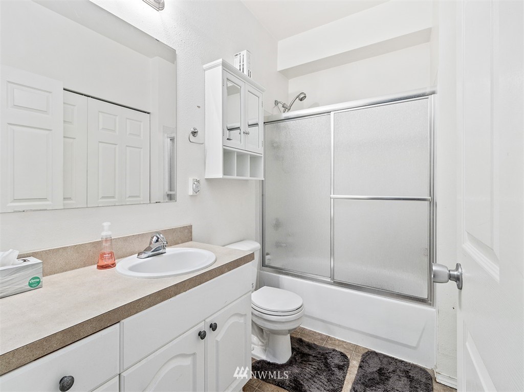 801 Rainier Avenue North, Unit G234 Renton, WA 98057 - Photo 13 of 19 a bathroom with a sink toilet and shower