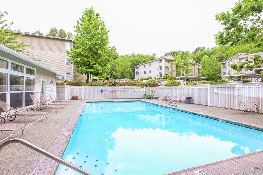 801 Rainier Avenue North, Unit G234 Renton, WA 98057 - Photo 18 of 19 swimming pool view with a outdoor space