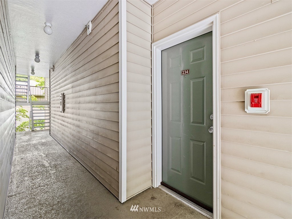 801 Rainier Avenue North, Unit G234 Renton, WA 98057 - Photo 3 of 19 a view of a door and chair in the balcony