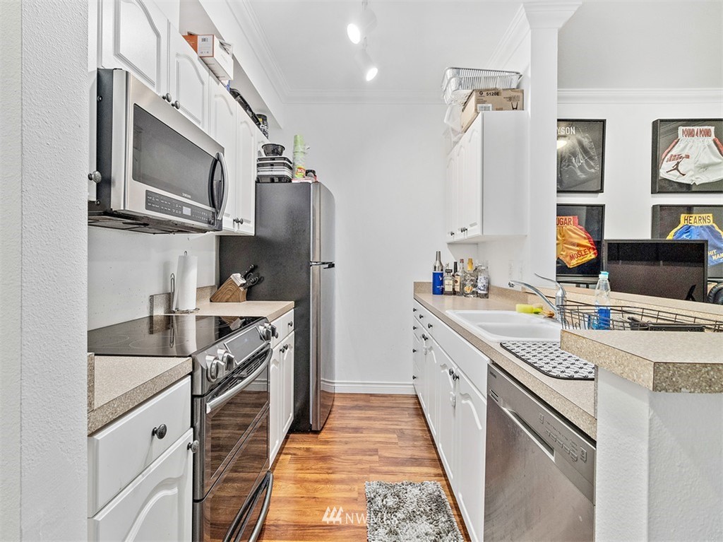 801 Rainier Avenue North, Unit G234 Renton, WA 98057 - Photo 7 of 19 a kitchen with stainless steel appliances granite countertop a sink and a stove