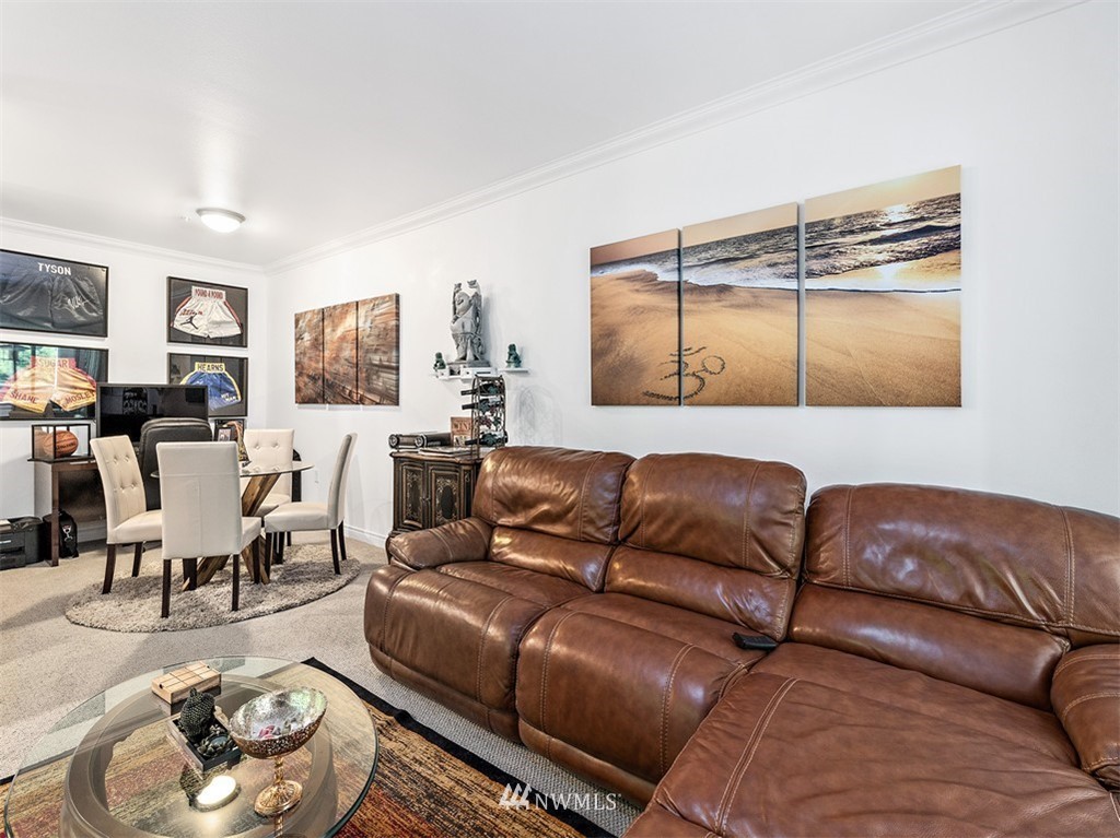 801 Rainier Avenue North, Unit G234 Renton, WA 98057 - Photo 10 of 19 a living room with furniture and wooden floor