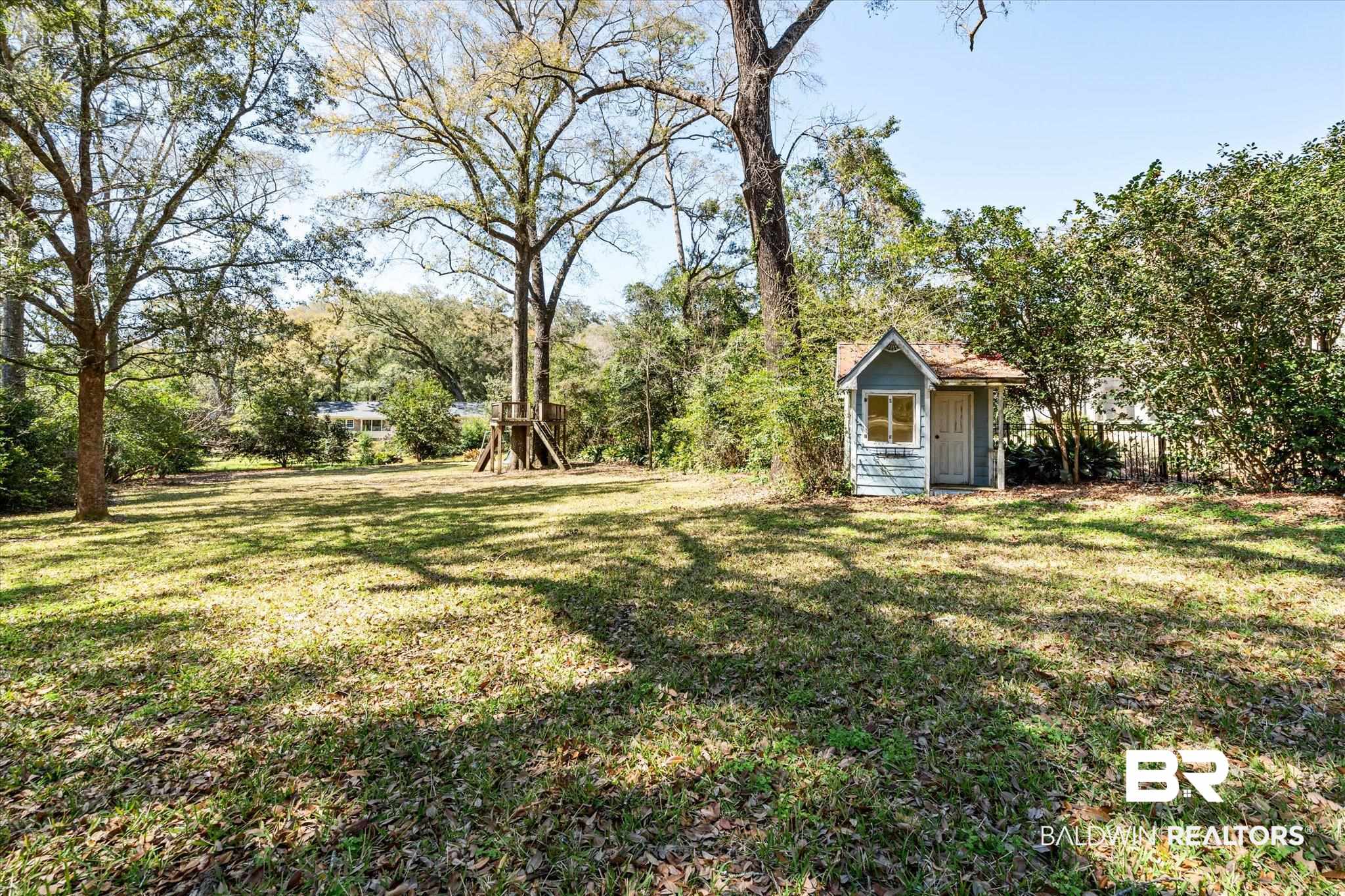 4 Kingsway Mobile, AL 36608 - Photo 34 of 44 View of yard featuring an outbuilding and a storage unit