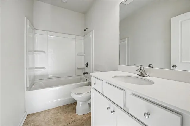 a bathroom with a sink toilet vanity and bathtub