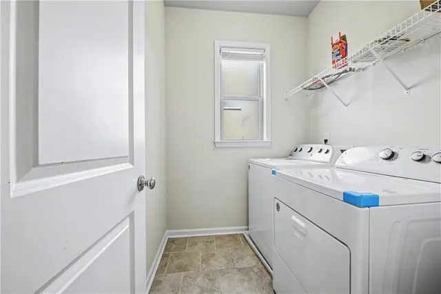 a utility room with cabinets washer and dryer