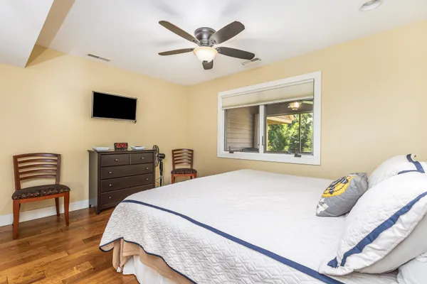 a bedroom with a bed and wooden floor