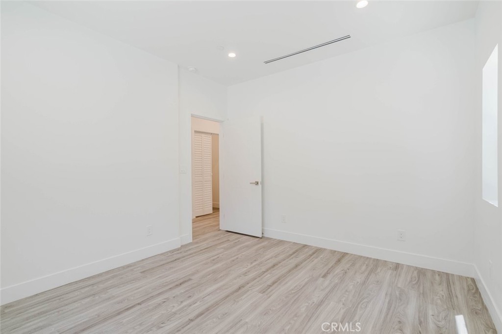 17846 Rinaldi Street Granada Hills, CA 91344 - Photo 8 of 34 a view of an empty room with wooden floor and closet