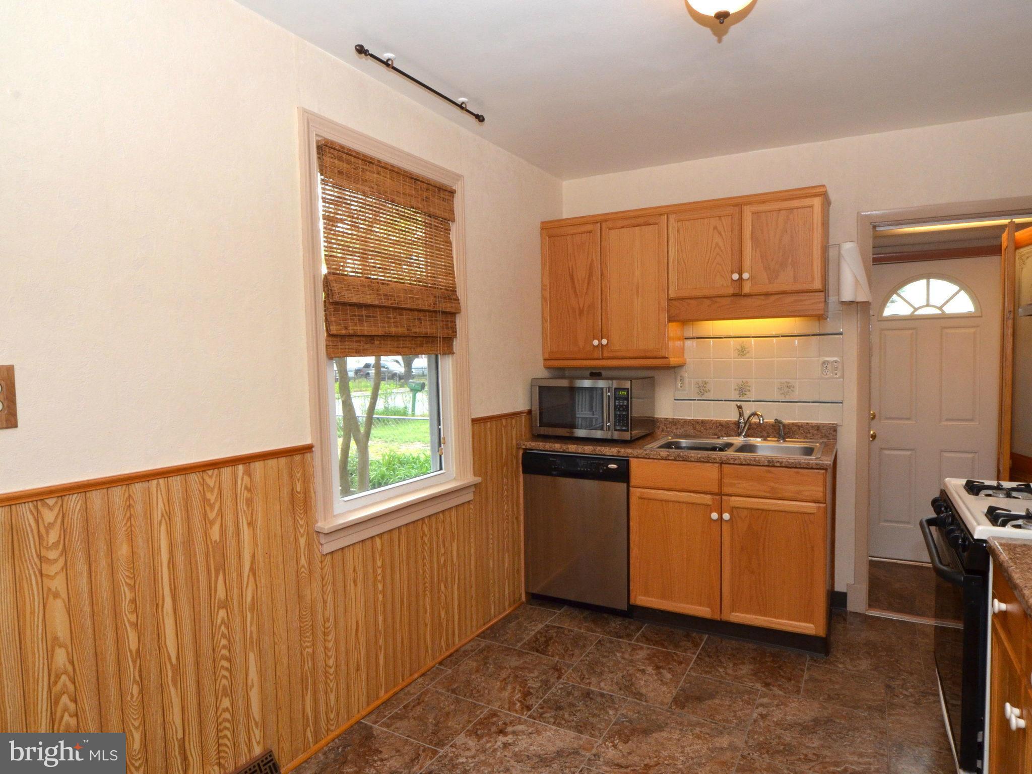 6720 Larkspur Road Morningside, MD 20746 - Photo 11 of 29 a kitchen with stainless steel appliances granite countertop a refrigerator a stove a sink and a window