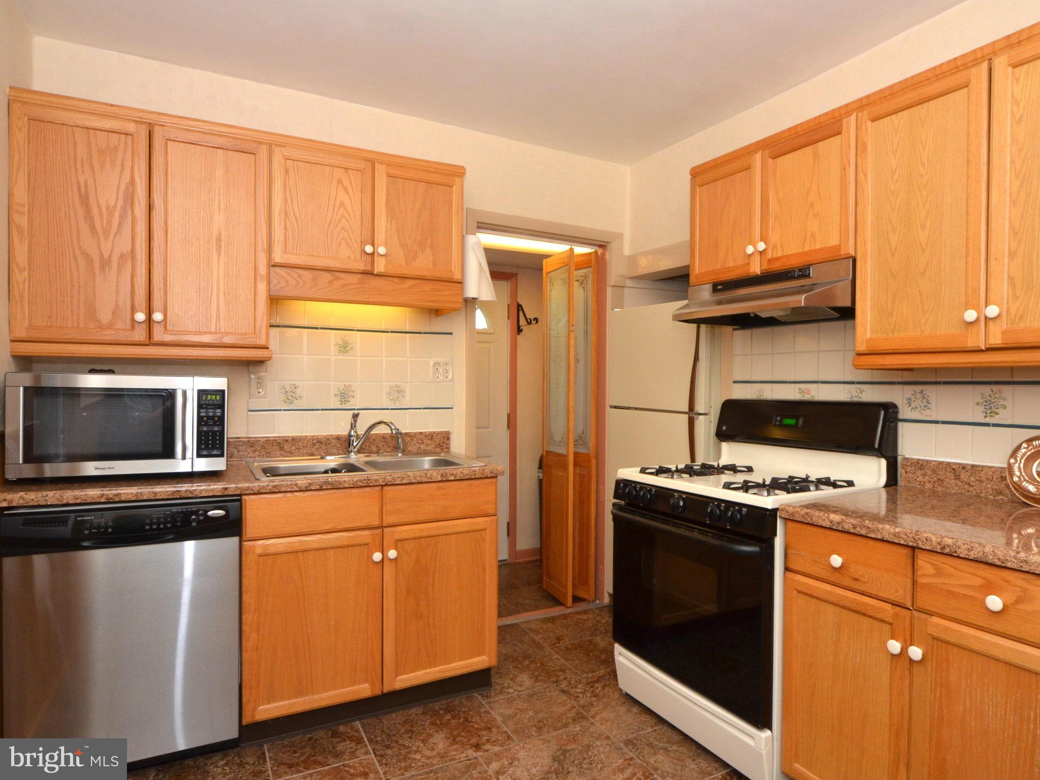 6720 Larkspur Road Morningside, MD 20746 - Photo 12 of 29 a kitchen with stainless steel appliances granite countertop a stove a sink dishwasher and a refrigerator