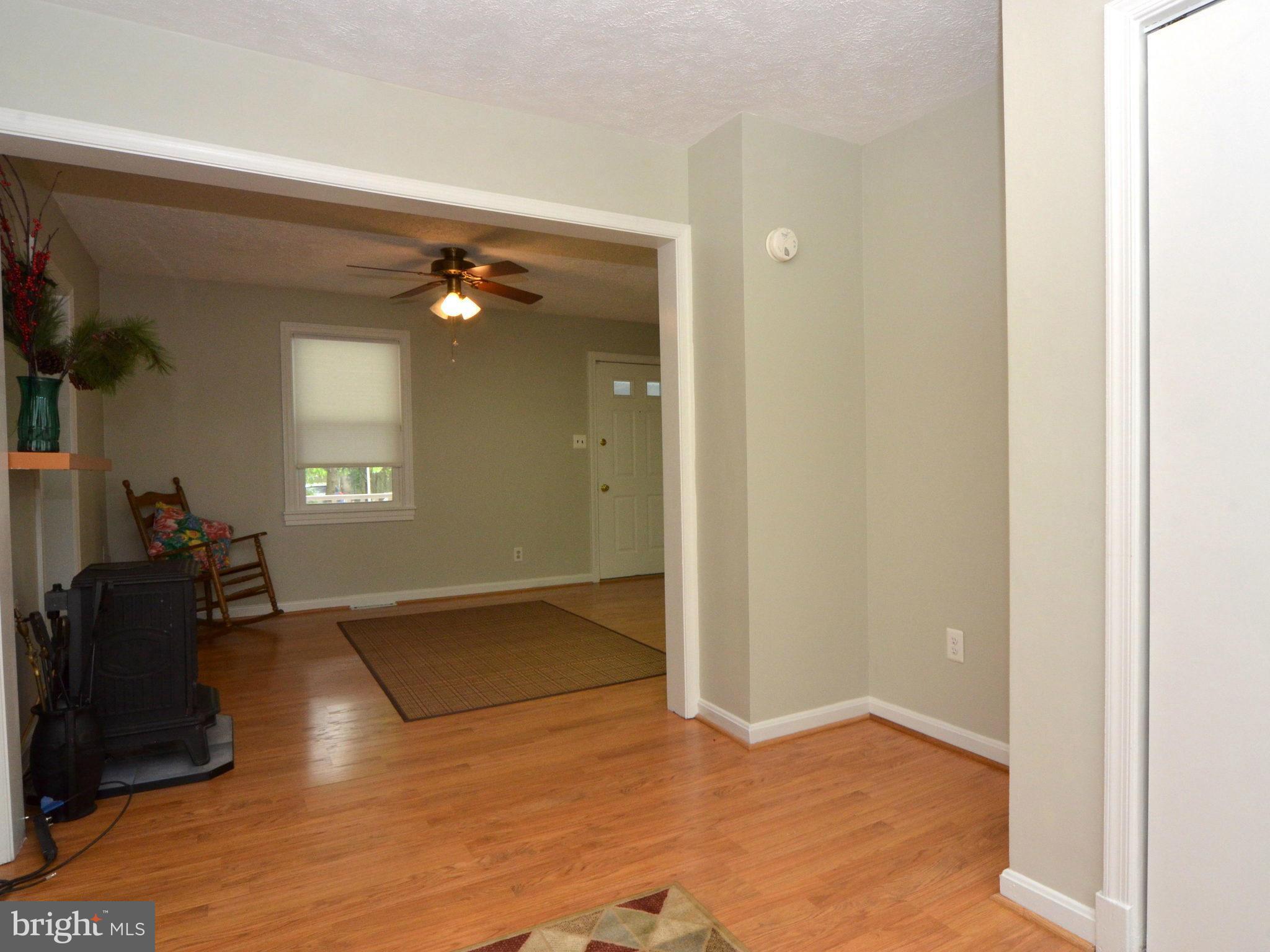6720 Larkspur Road Morningside, MD 20746 - Photo 2 of 29 a view of livingroom with hardwood floor and a ceiling fan
