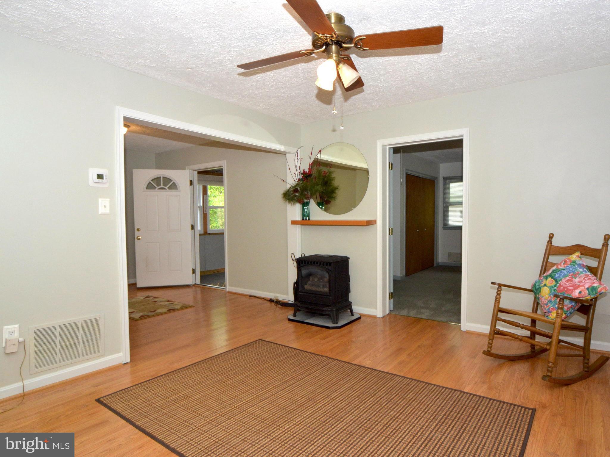 6720 Larkspur Road Morningside, MD 20746 - Photo 4 of 29 a living room with furniture and a fireplace