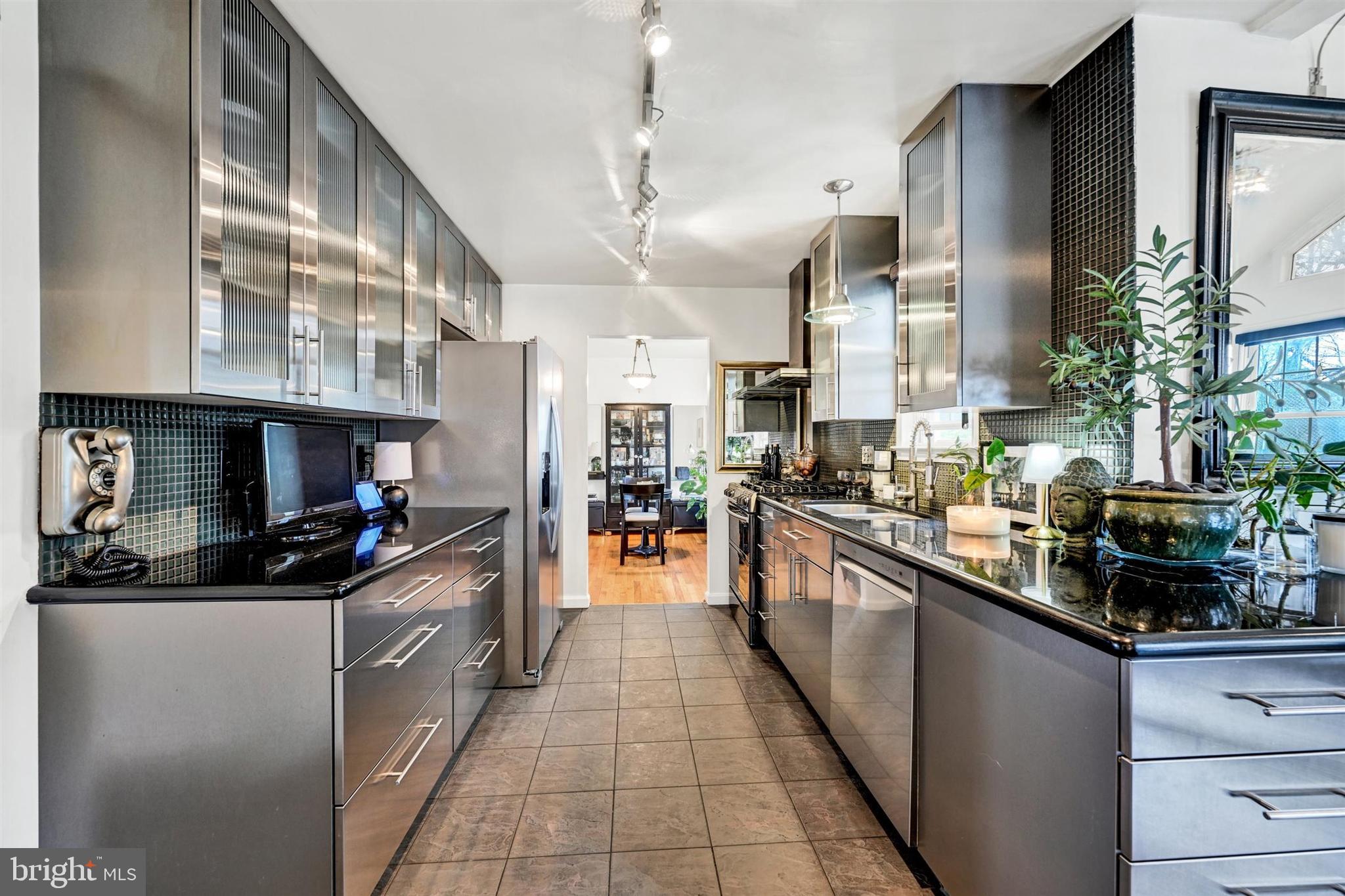 9206 Muskogee Place Adelphi, MD 20783 - Photo 11 of 43 a kitchen with stainless steel appliances granite countertop a sink and cabinets