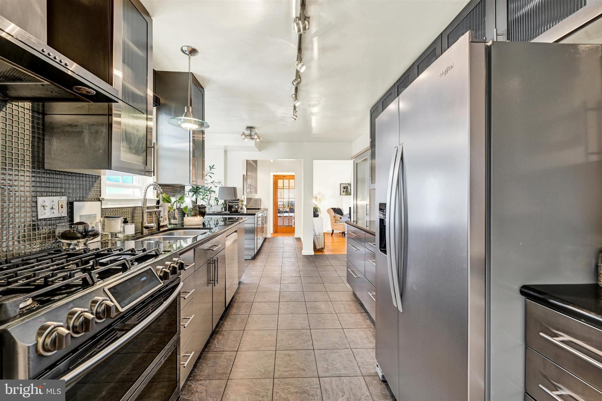 9206 Muskogee Place Adelphi, MD 20783 - Photo 14 of 43 a large kitchen with stainless steel appliances