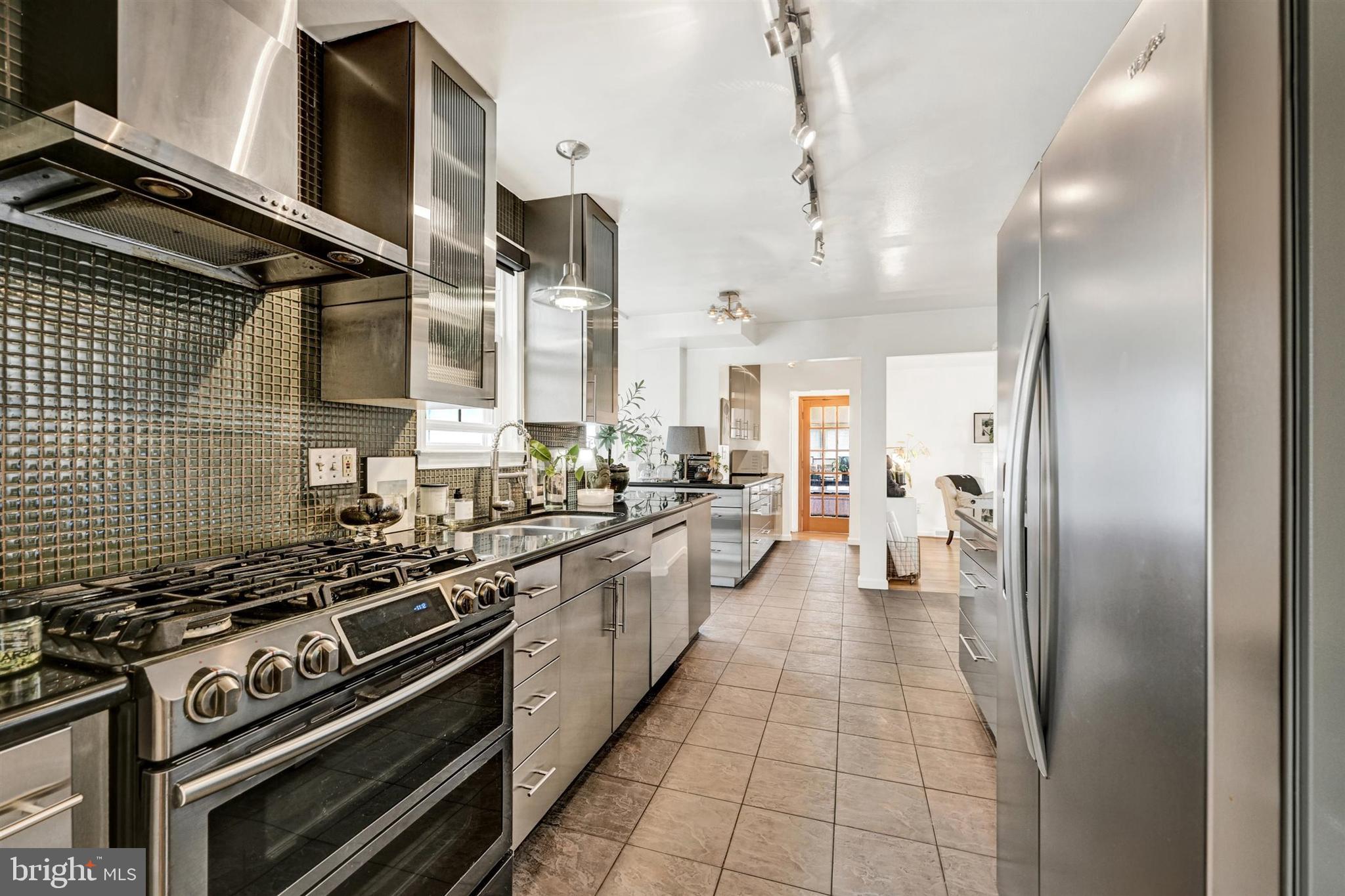 9206 Muskogee Place Adelphi, MD 20783 - Photo 15 of 43 a kitchen with stainless steel appliances granite countertop a stove and a refrigerator