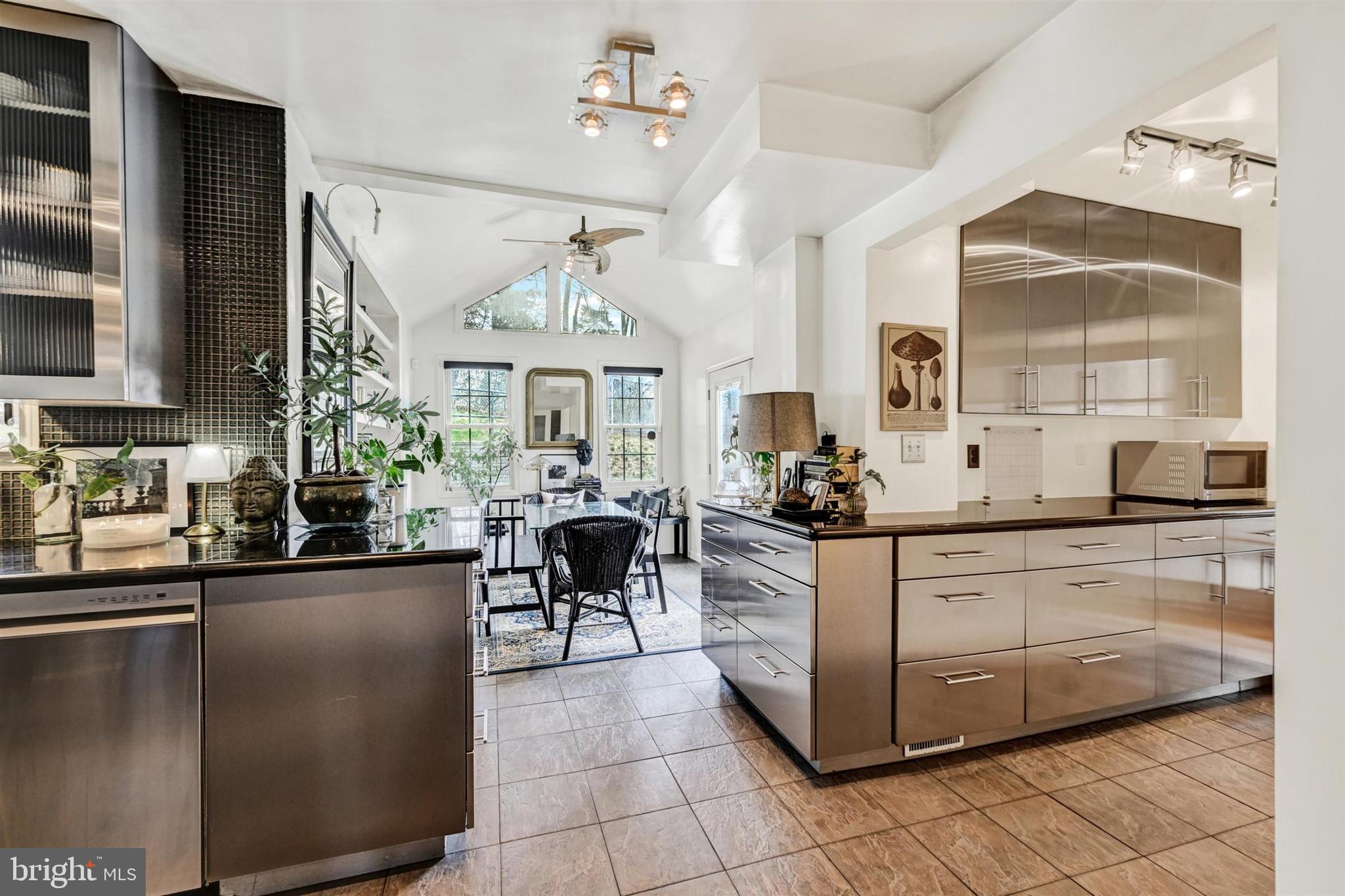 9206 Muskogee Place Adelphi, MD 20783 - Photo 16 of 43 a kitchen with stainless steel appliances granite countertop a sink and cabinets