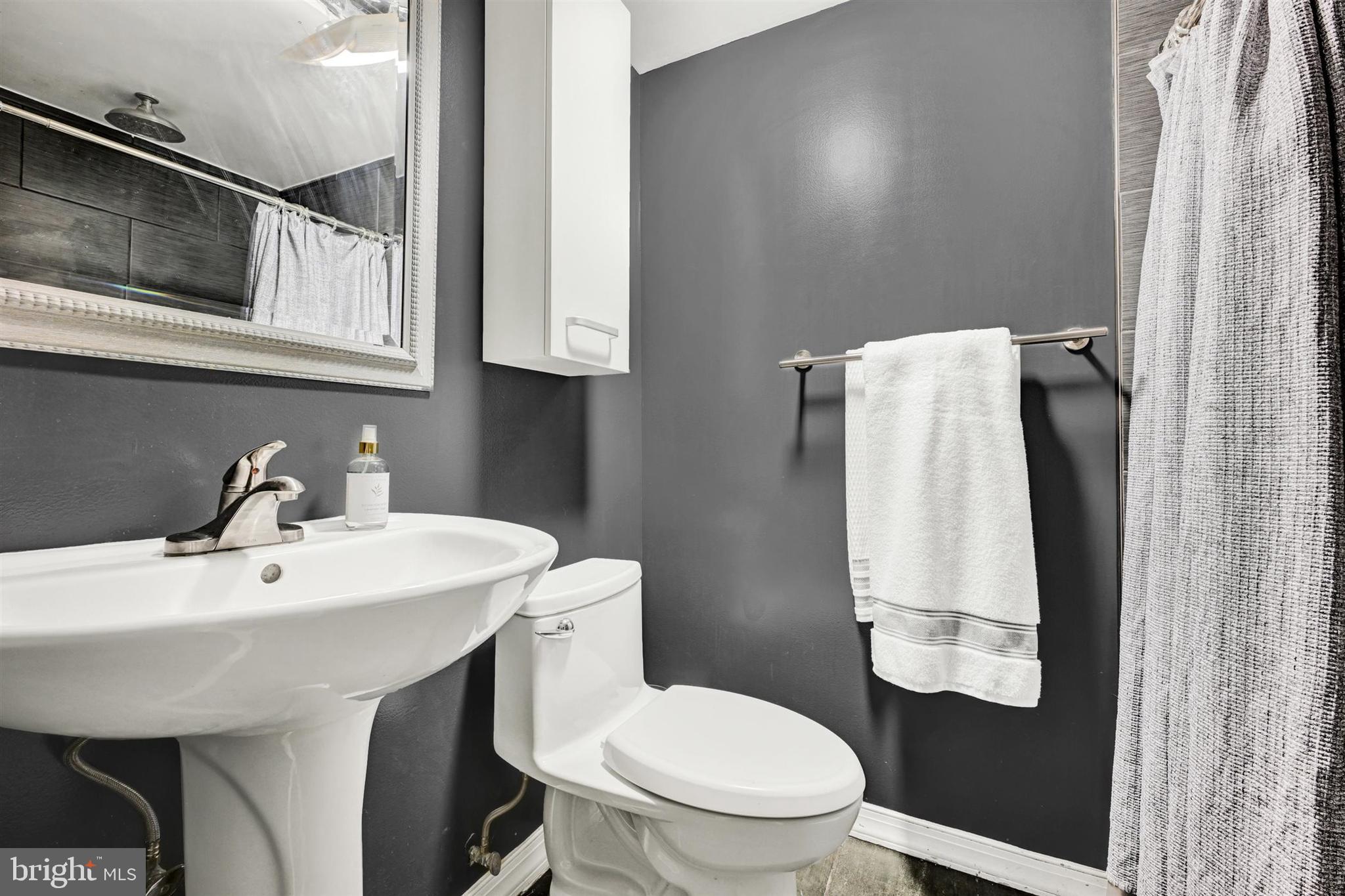 9206 Muskogee Place Adelphi, MD 20783 - Photo 31 of 43 a bathroom with a sink toilet and mirror