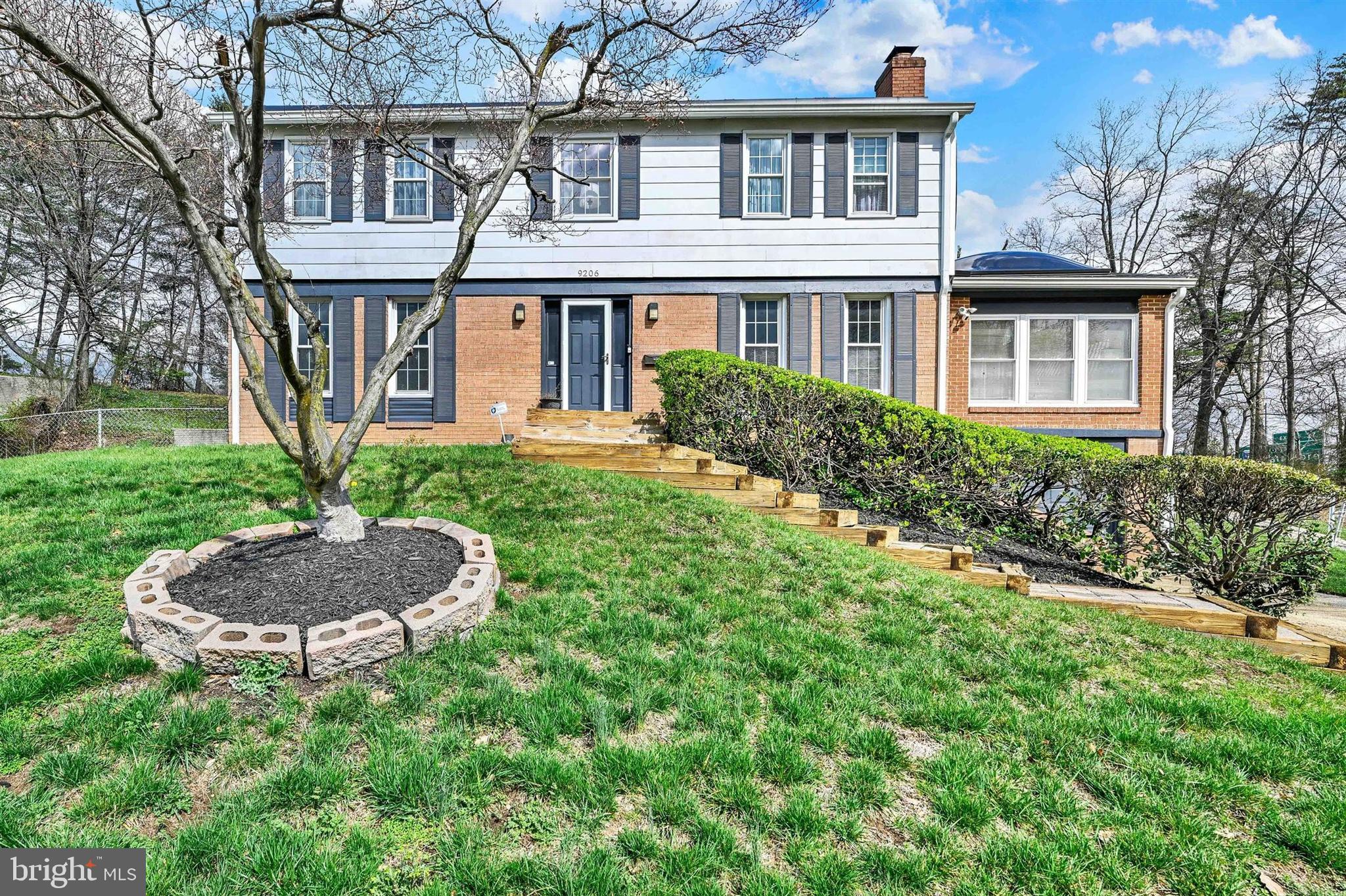 9206 Muskogee Place Adelphi, MD 20783 - Photo 39 of 43 a front view of a house with a yard and green space