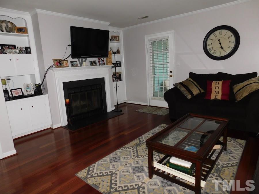 4428 Roller Court Raleigh, NC 27604 - Photo 5 of 10 a living room with furniture and a flat screen tv