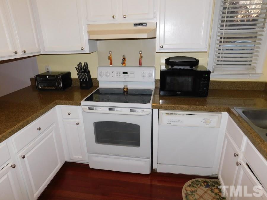 4428 Roller Court Raleigh, NC 27604 - Photo 6 of 10 a kitchen with appliances cabinets and a wooden floor
