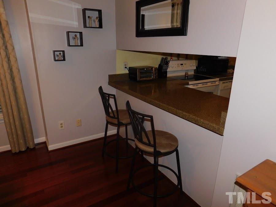 4428 Roller Court Raleigh, NC 27604 - Photo 7 of 10 a view of a workspace with furniture and wooden floor