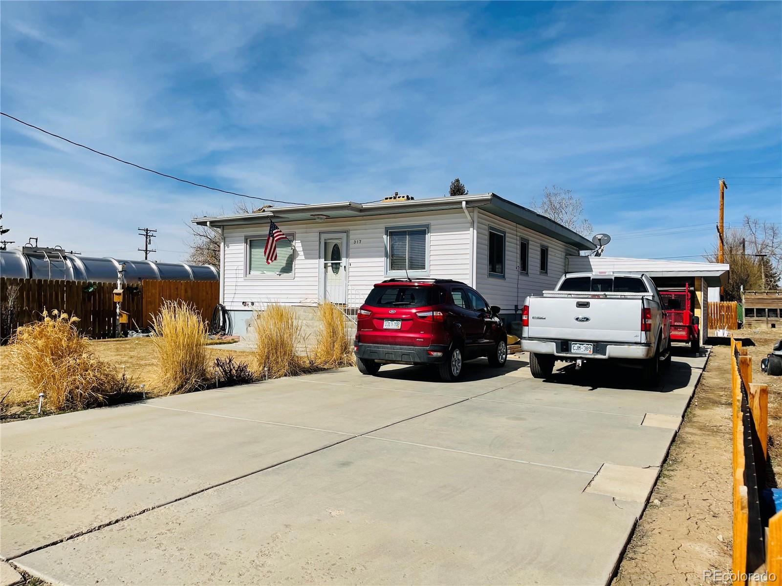 317 9th Street Gilcrest, CO 80623 - Photo 1 of 15 a car parked in front of a house