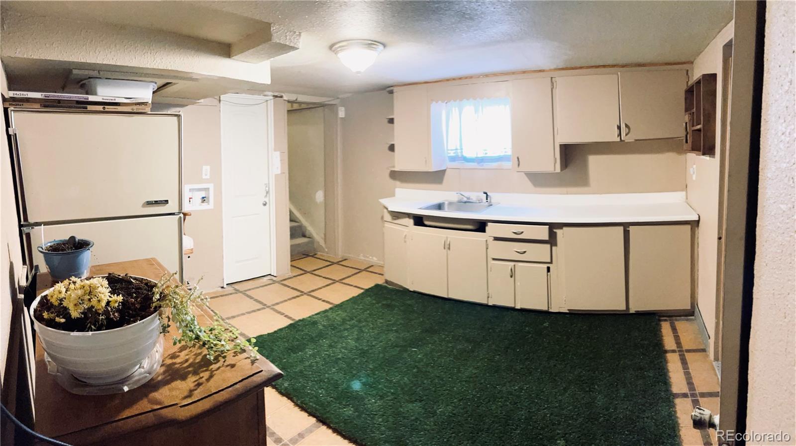 317 9th Street Gilcrest, CO 80623 - Photo 14 of 15 a kitchen with a refrigerator and a stove