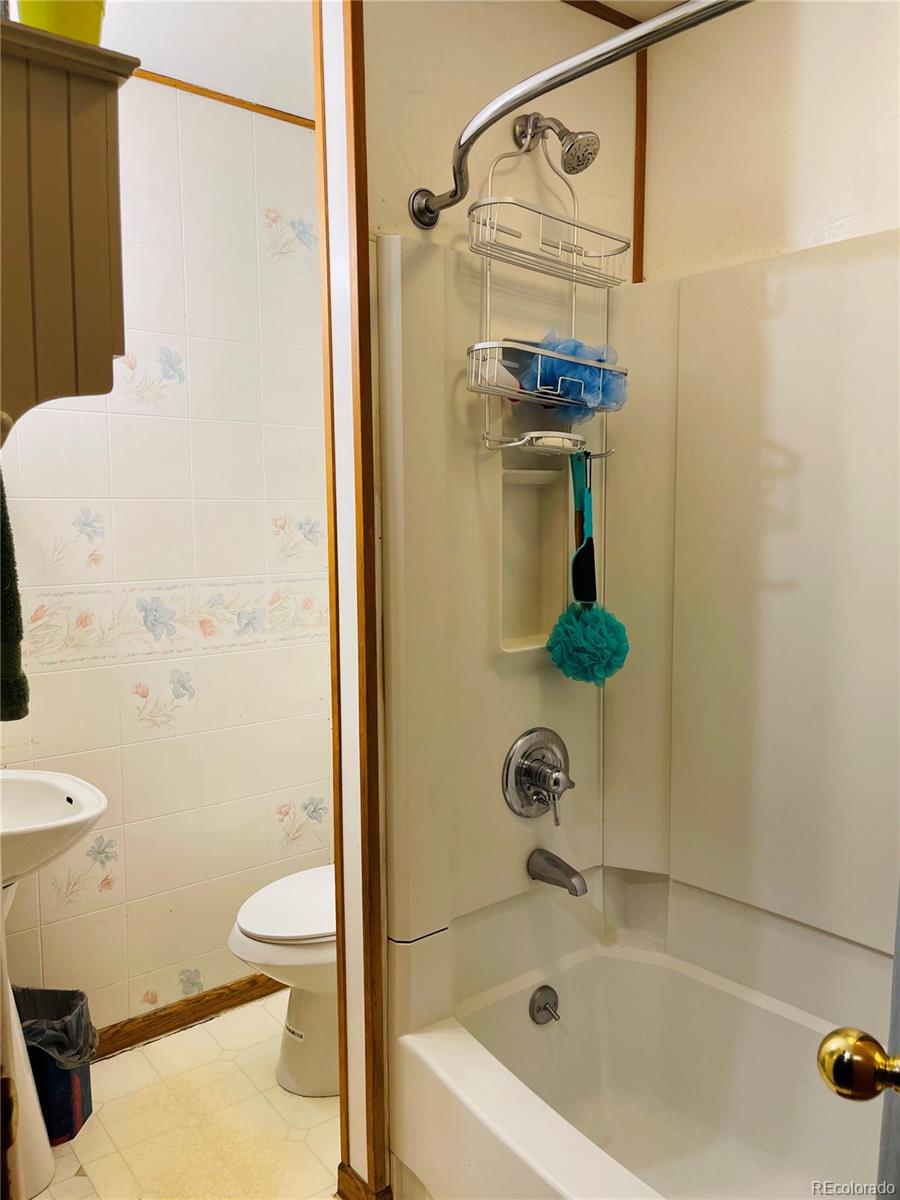 317 9th Street Gilcrest, CO 80623 - Photo 6 of 15 a bathroom with a shower and a toilet