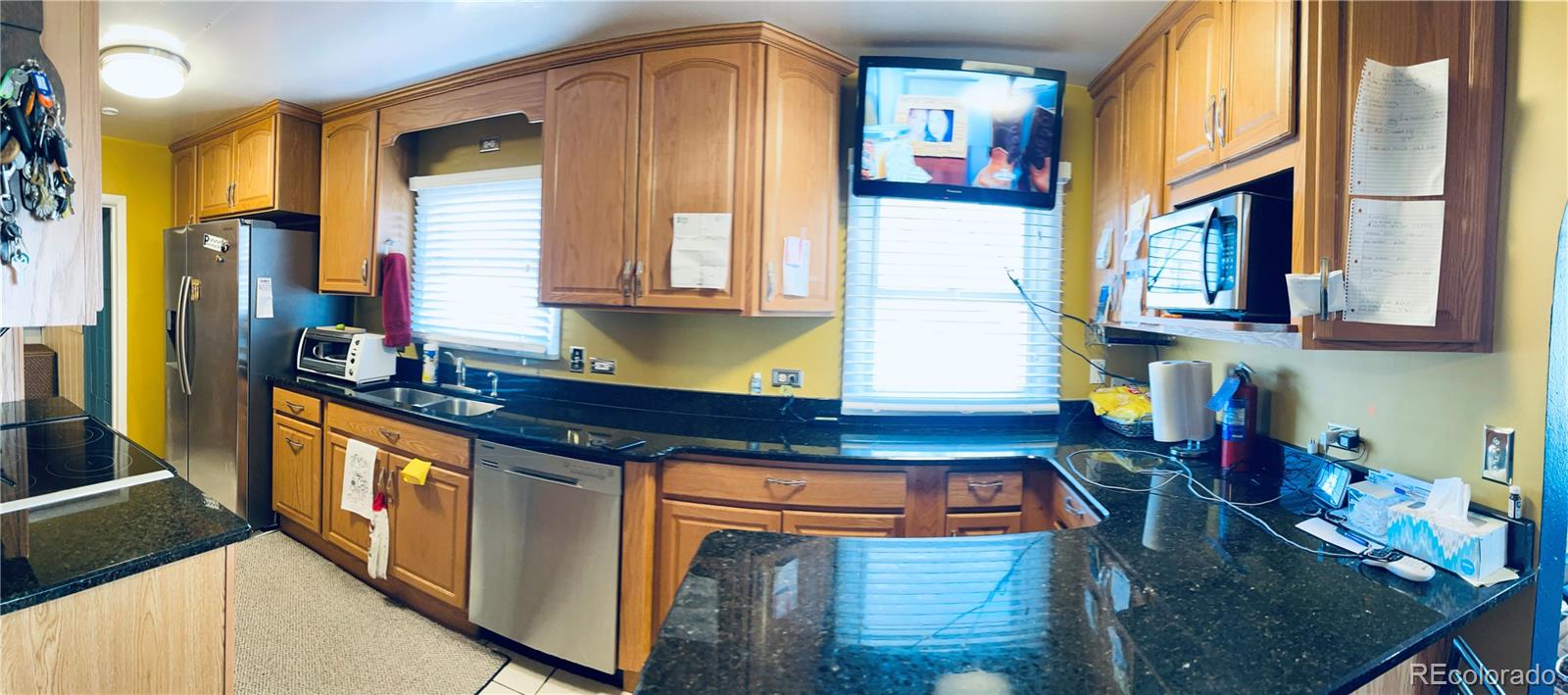 317 9th Street Gilcrest, CO 80623 - Photo 7 of 15 a kitchen with stainless steel appliances granite countertop a stove a sink and a refrigerator