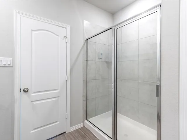 a bathroom with a glass shower door