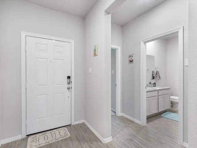 wooden floor with white cabinets