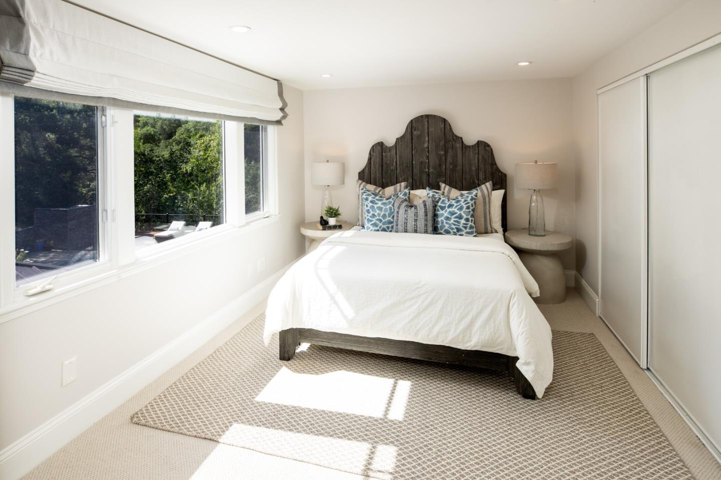 345 Harcross Road Woodside, CA 94062 - Photo 22 of 37 a bedroom with a large bed and a large window