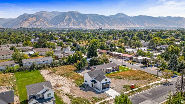 612 North 400 West Logan, UT 84321 - Photo 7 of 27 Aerial perspective featuring a modern two-story residence with a two-car garage, a concrete driveway, and a partially landscaped lot