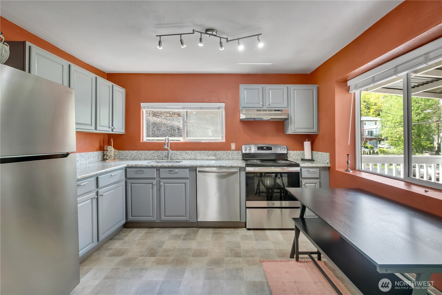 2307 Southwest Myrtle Street Seattle, WA 98106 - Photo 10 of 30 a kitchen with stainless steel appliances granite countertop a stove a sink and a refrigerator