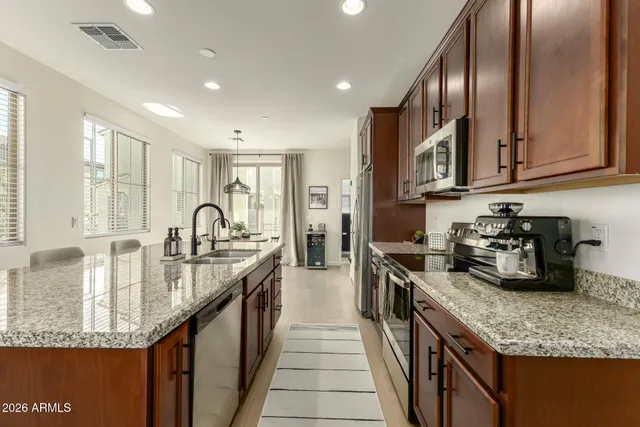a kitchen with sink stove and cabinets