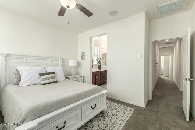 a bedroom with a large bed and a chandelier