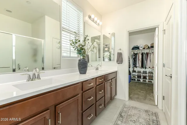 a spacious bathroom with a double vanity sink and a mirror