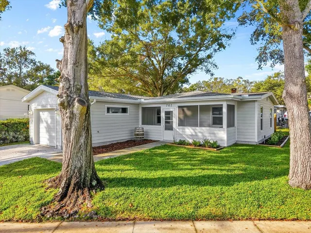 a front view of house with a garden and patio