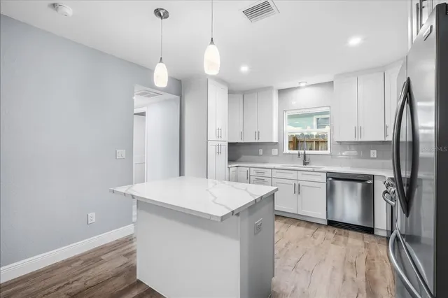 a kitchen with a refrigerator a sink and dishwasher