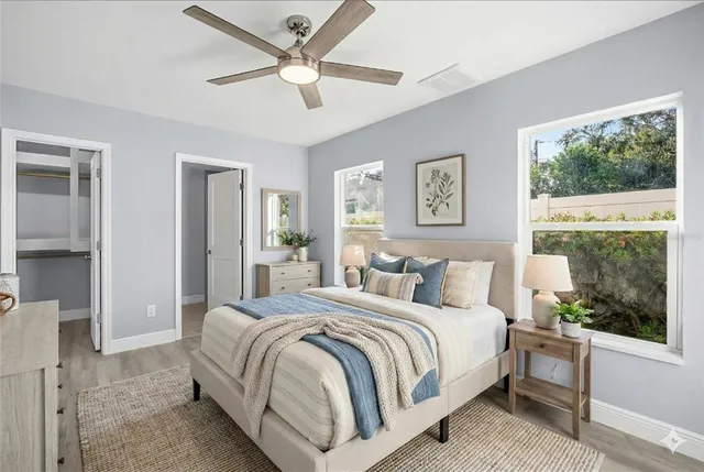 a bedroom with a large bed and a window