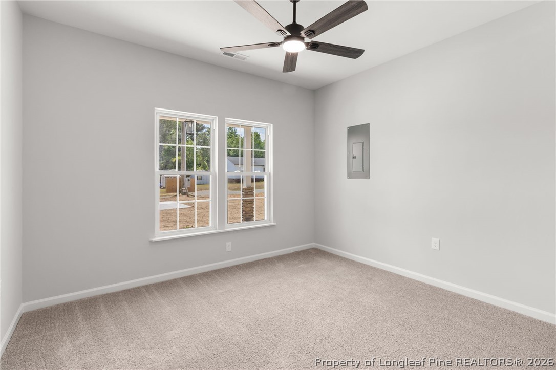 802 Holmes Street Clinton, NC 28328 - Photo 12 of 31 an empty room with a window and a fan