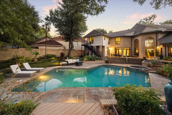 a view of a house with swimming pool and sitting area