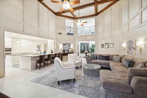 a living room with furniture and a dining table