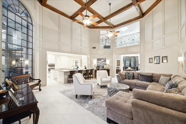 a dining hall with stainless steel appliances granite countertop a sink a stove a dining table and chairs
