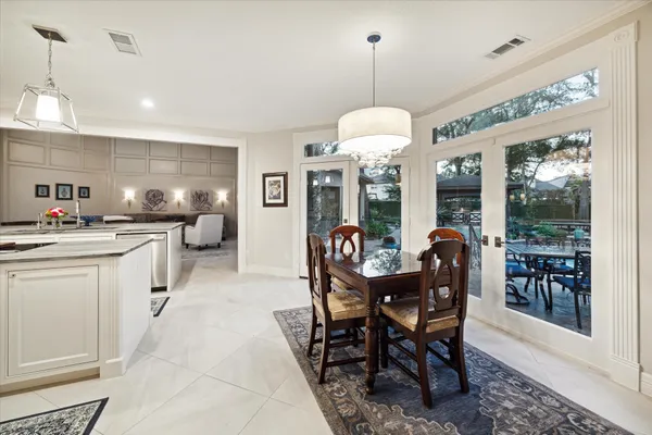 a large kitchen with a table and chairs