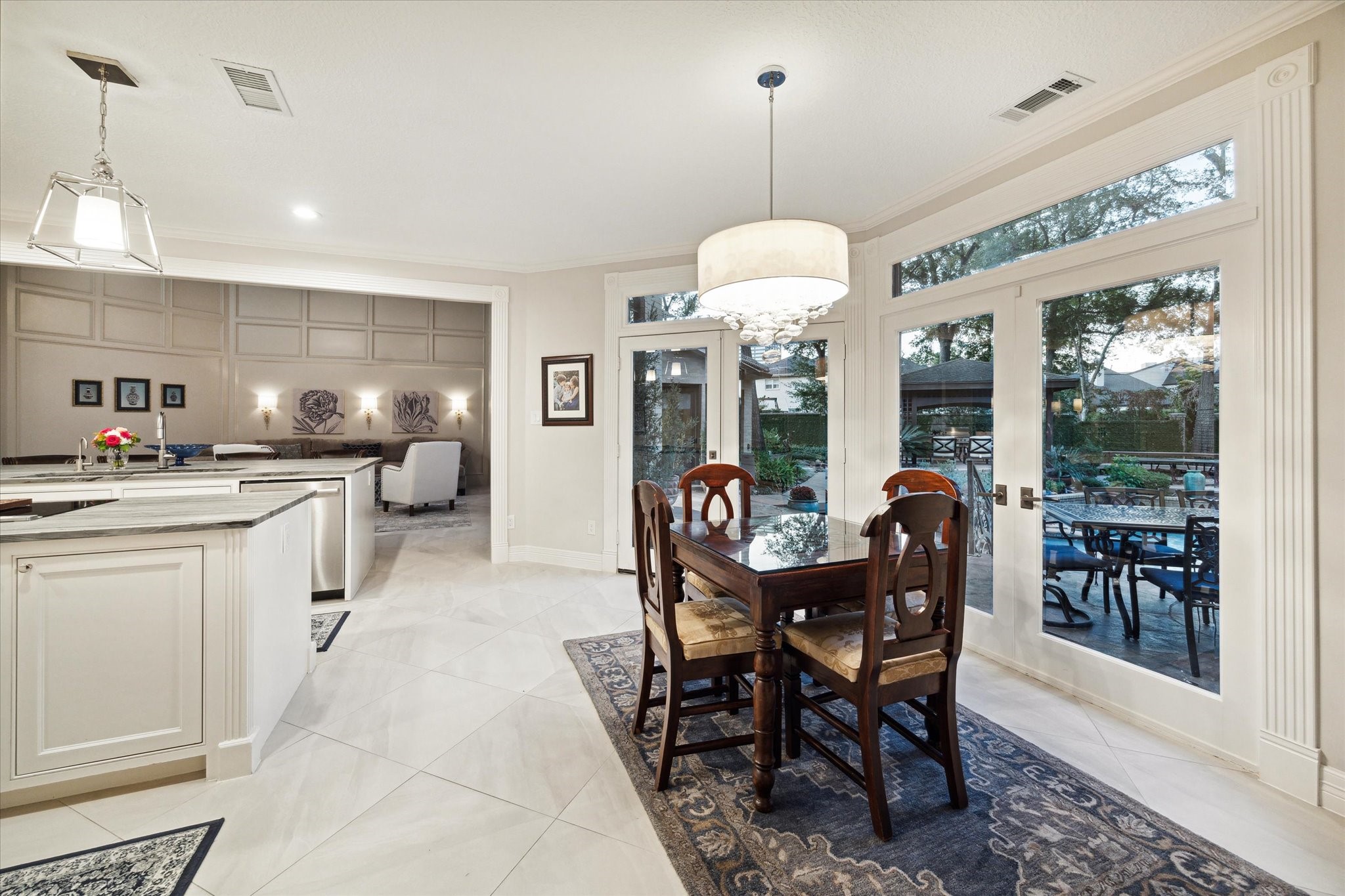 15406 Old Stone Trail Houston, TX 77079 - Photo 13 of 42 Spacious, open-concept dining and kitchen area with modern finishes, ample natural light, and a view of an inviting outdoor patio.