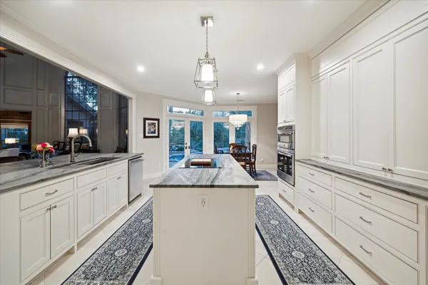 a kitchen with stainless steel appliances kitchen island granite countertop a sink and cabinets