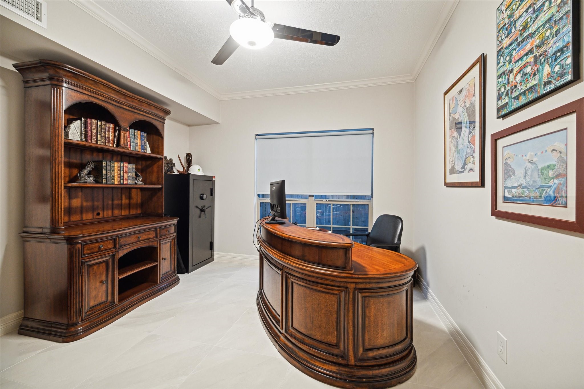 15406 Old Stone Trail Houston, TX 77079 - Photo 17 of 42 This is a well-maintained home office space featuring a ceiling fan and has large windows that allow for plenty of natural light.