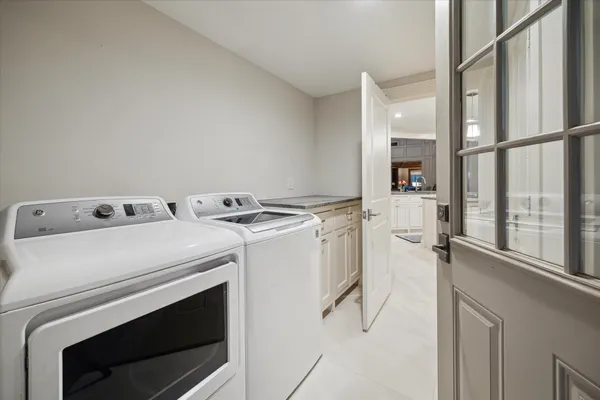 a bathroom with a granite countertop double vanity sink and mirror
