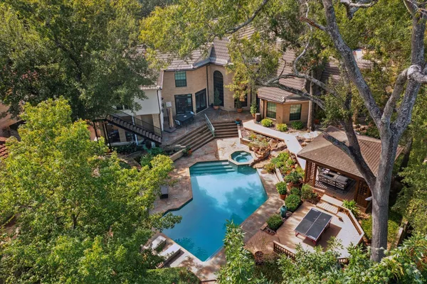 an aerial view of a house with a yard basket ball court and outdoor seating
