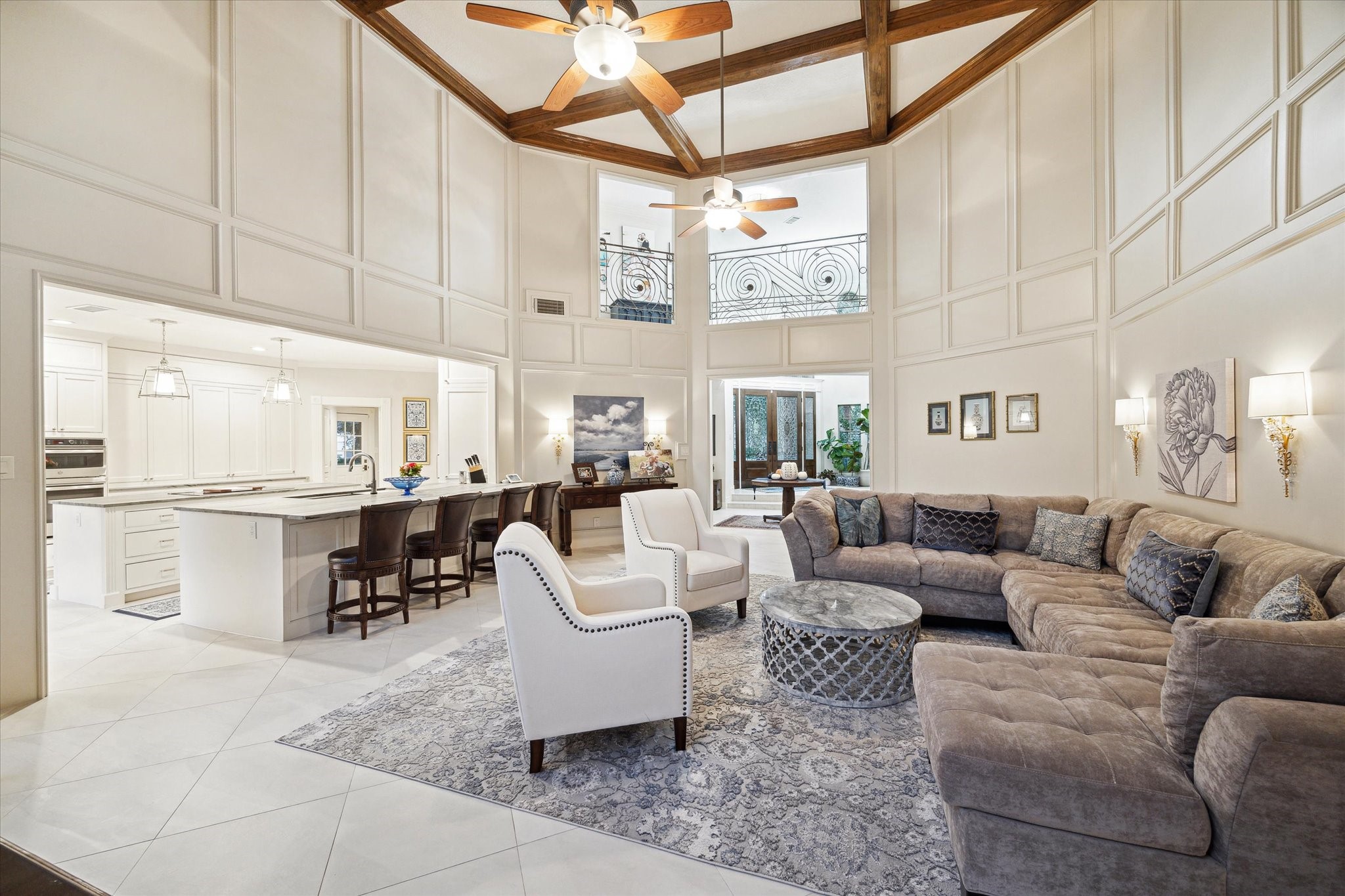 15406 Old Stone Trail Houston, TX 77079 - Photo 9 of 42 This is an elegant, open-concept living space featuring high ceilings with exposed beams, a sophisticated neutral color palette, and an abundance of natural light.