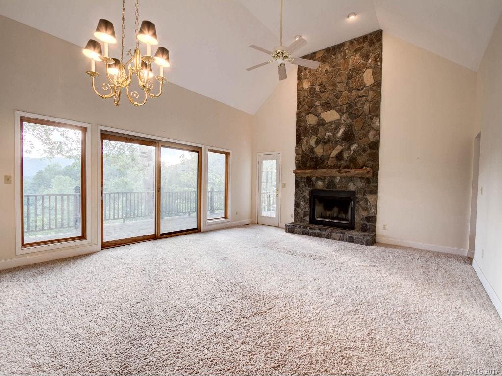 686 Fontana View Road, Unit 56 Bryson City, NC 28713 - Photo 5 of 24 an empty room with windows chandelier and a fireplace